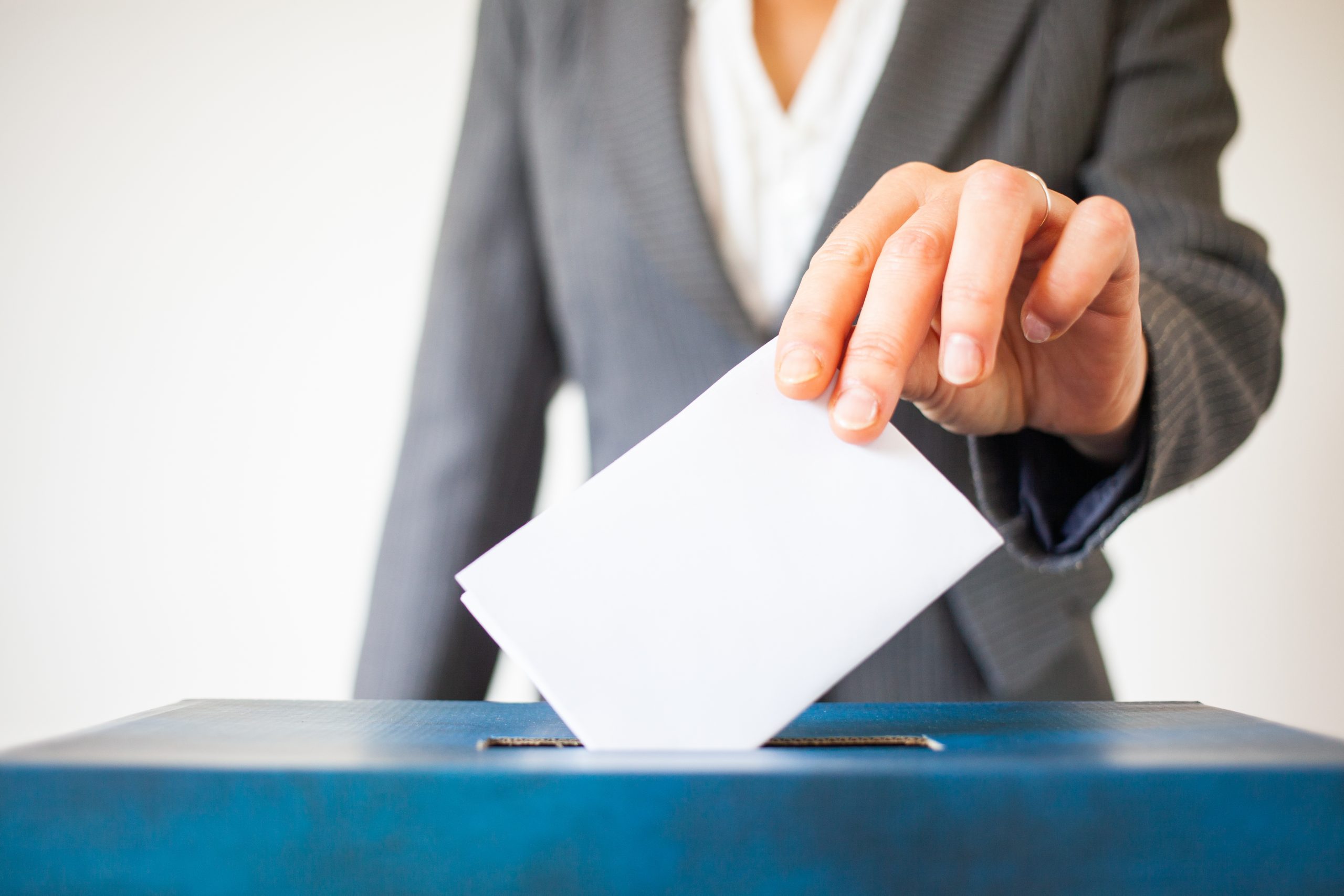 elections - The hand of woman putting her vote in the ballot box