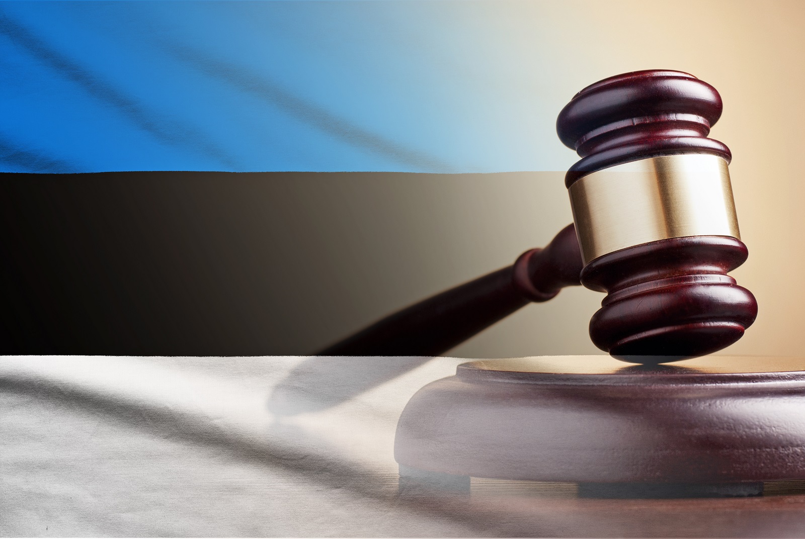 Lawyers wooden gavel over the flag of Estonia