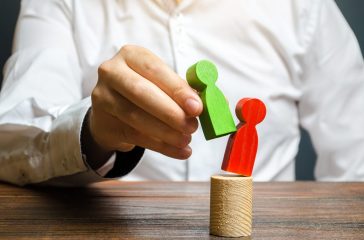 A person replaces a red human figure with a green one. firing staff. Head Offset. Business optimization, replacement of key employees with loyal ones. Change of power. Anti corruption. system recovery