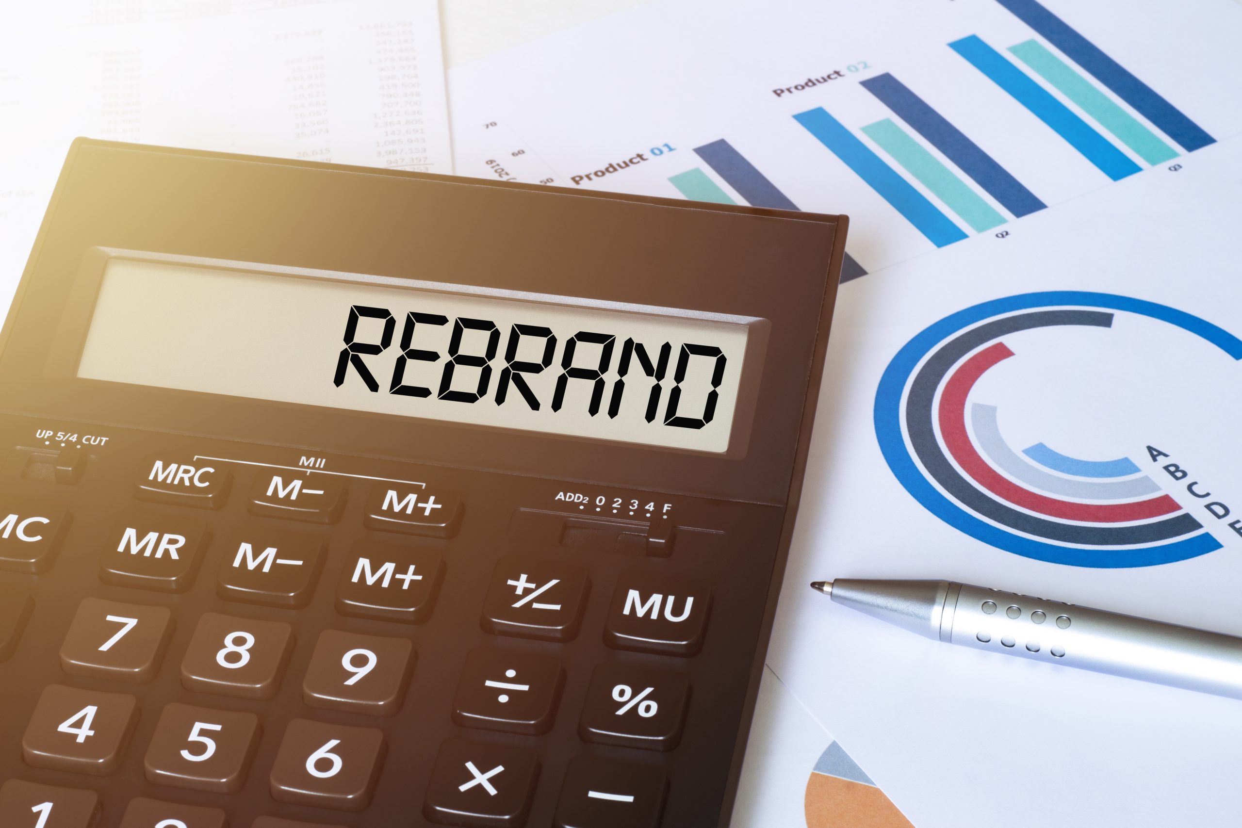 Word REBRAND on calculator. Business and finance concept.