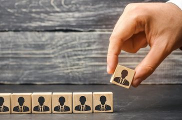 The leader builds team from cubes with employees. Businessman in search of new employees and specialists. personnel selection and management within the team. removes / dismisses the employee