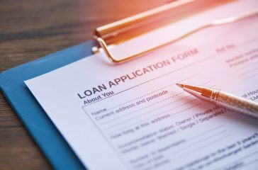 Loan application form with pen on paper / financial loan negotiation for lender and borrower