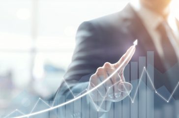 Development and growth concept. Businessman plan growth and increase of positive indicators in his business.