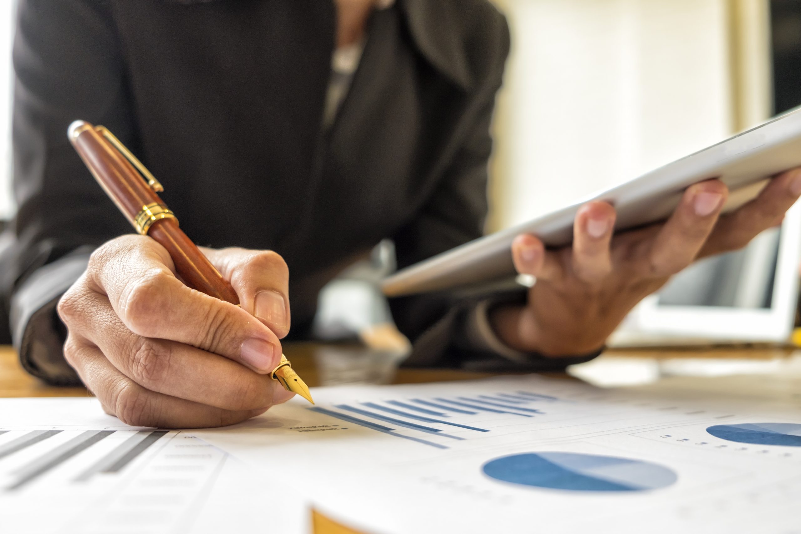 Businesswomen analyzing investment charts in meeting room