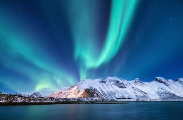 Northen light under mountains. Beautiful natural landscape in the Norway
