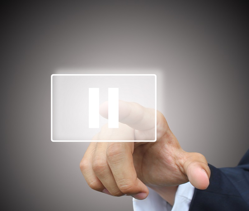 Business hand press pause button