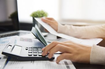Woman calculating her Debt.