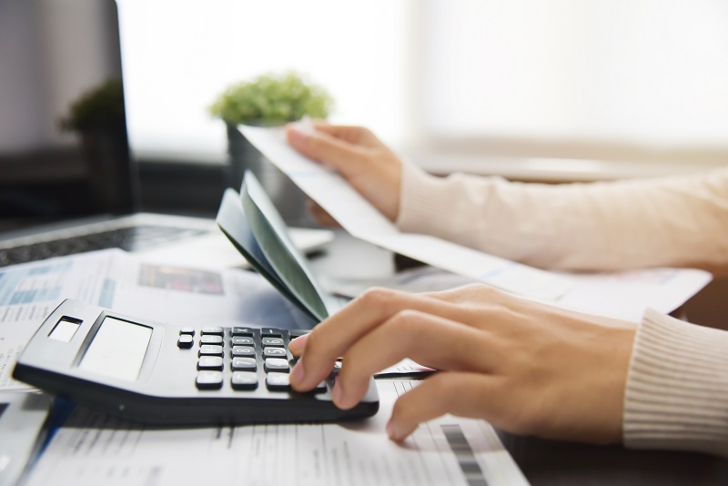Woman calculating her Debt.