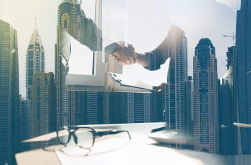 Businessmen making handshake in office
