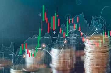 Graph and rows of coins for finance and business, stock market chart growth, abstract and symbol, business investment and currency exchange, on blue background.