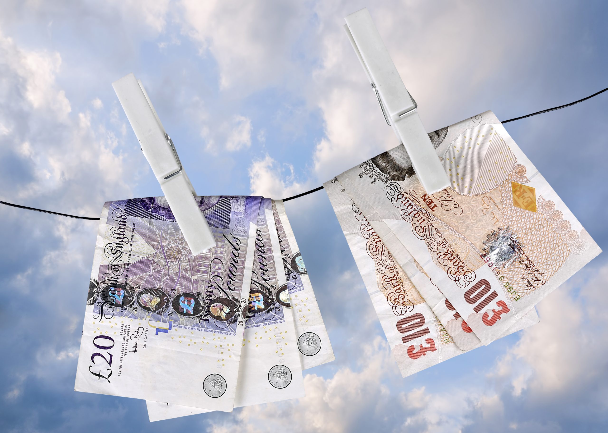 UK pounds dry on washing line pegs- financial metaphor