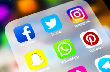 Sankt-Petersburg, Russia, March 6, 2018: Apple iPhone X with icons of social media facebook, instagram, twitter, snapchat application on screen. Social media icons. Social media network