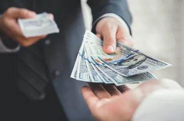 Businessman giving or paying money to a man