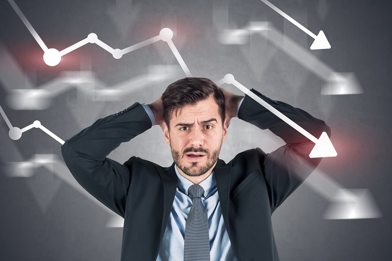 Confused businessman, falling graphs