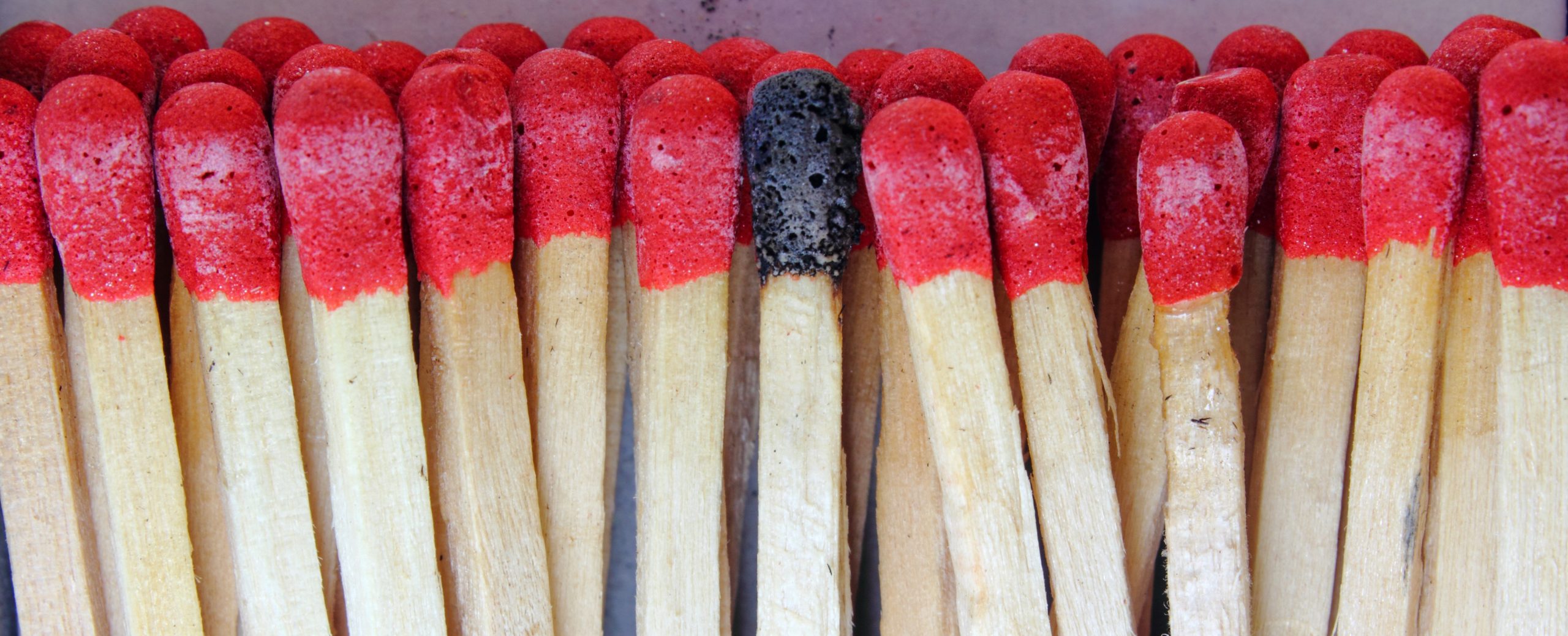 panoramic closeup of matches with burnt match head