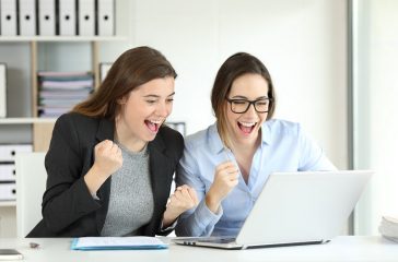 Two excited executives celebrating success