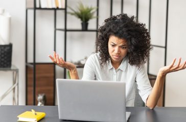 African-American female office worker stressing out