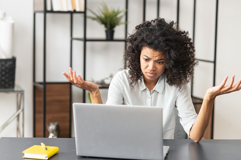 African-American female office worker stressing out