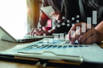 business documents on office table with smart phone and digital