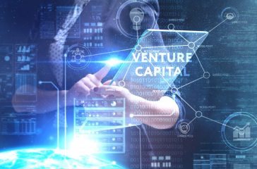 The concept of business, technology, the Internet and the network. A young entrepreneur working on a virtual screen of the future and sees the inscription: Venture capital