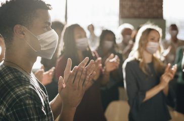 Business party in new normal with crowded people wearing masks