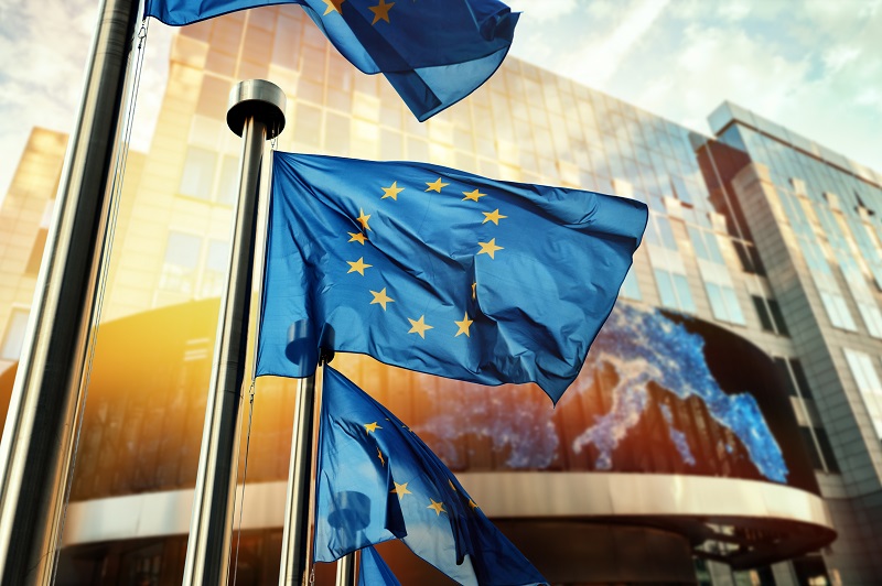 EU flags waving in front of European Parliament building. Brussels, Belgium