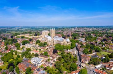Aerial footage of the Lincoln Cathedral, Lincoln Minster in the UK city centre of Lincoln East Midlands on a bright sunny summers day showing the historic Cathedral Church in the British city centre