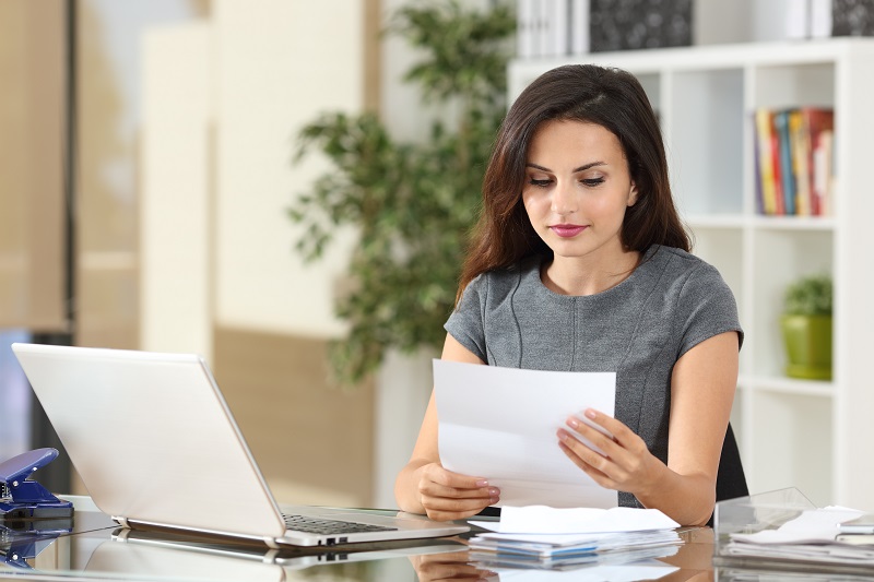 Businesswoman reading a letter at office