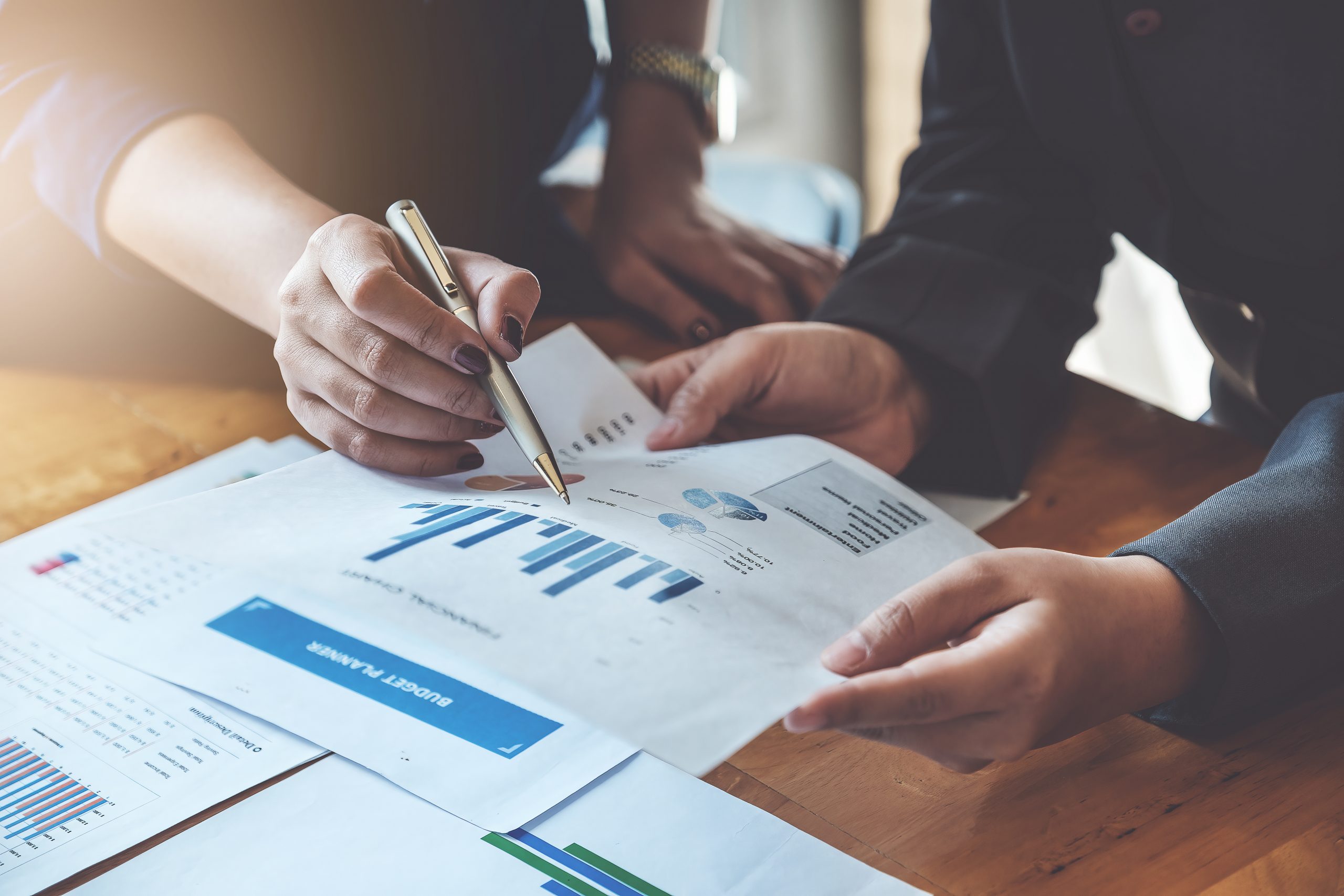 Business People Meeting to discuss and brainstorming the financial report paperwork in home office. Financial advisor teamwork and accounting concept.