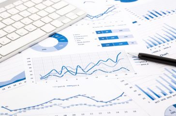 blue graph and chart reports on office table