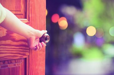 Women hand open door knob or opening the door.
