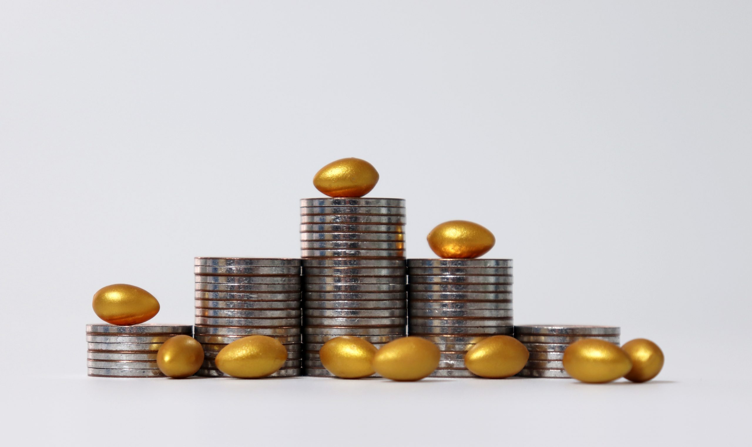 Piles of coins and golden eggs.