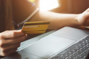 Close up female hands holding smart phone and credit card for on