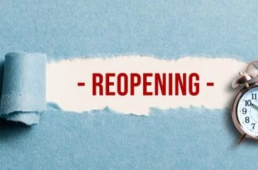 torn paper revealing the word REOPENING on white background