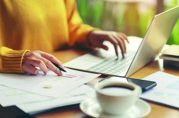 Young accountant woman checking paperwork from accounting depart
