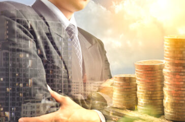 Businessman,And,Stack,Coins,And,Building,Shadow,Success,Business,Financial LandlordInvest