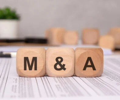 wooden blocks with 'M and A' letters on financial documents, symbolizing mergers and acquisitions Oaktree Capital Management is reportedly using private credit from Ares and Barings to acquire Perpetual's wealth management arm.