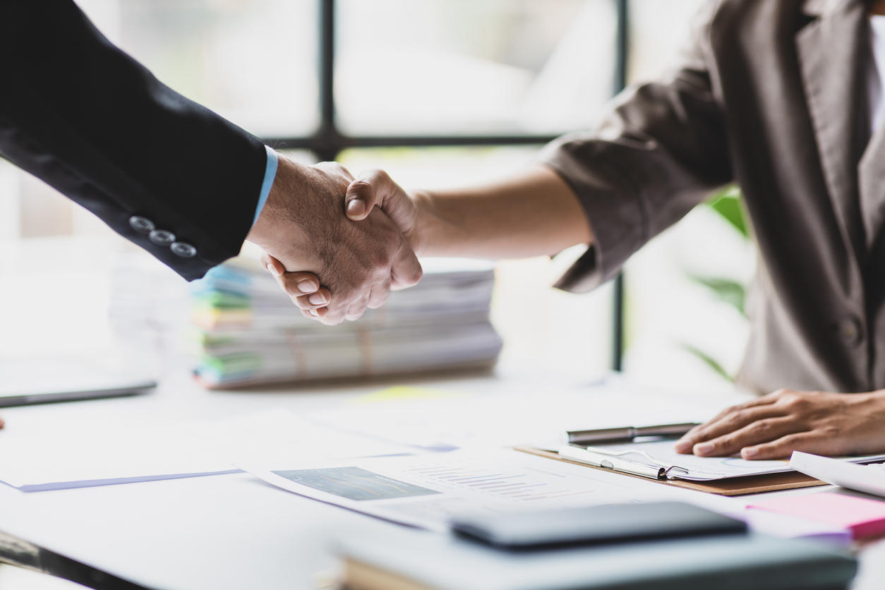 Handshake, Business cooperation at a meeting of business people. Business partners shaking hands in a meeting.